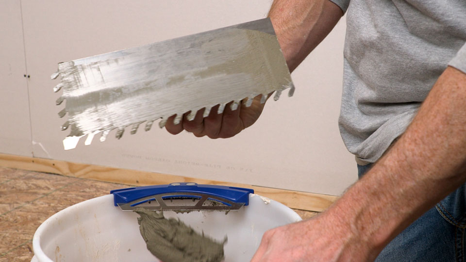 clean trowel from scraping and mortar falling into the bucket